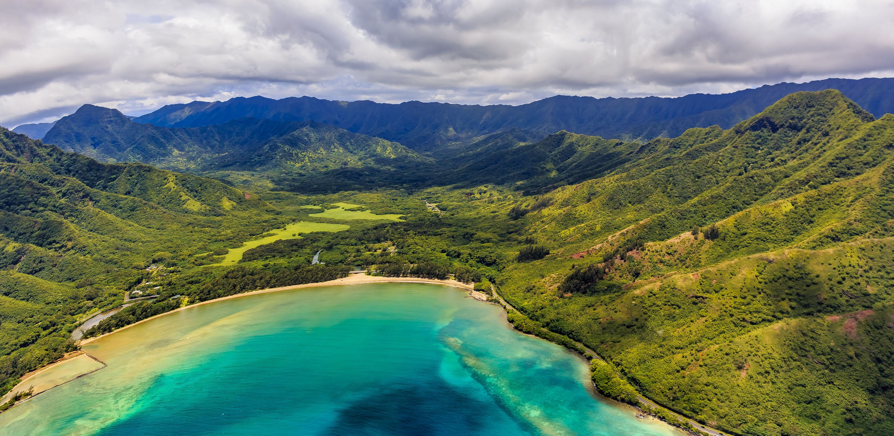 a aerial view of a beach and mountains