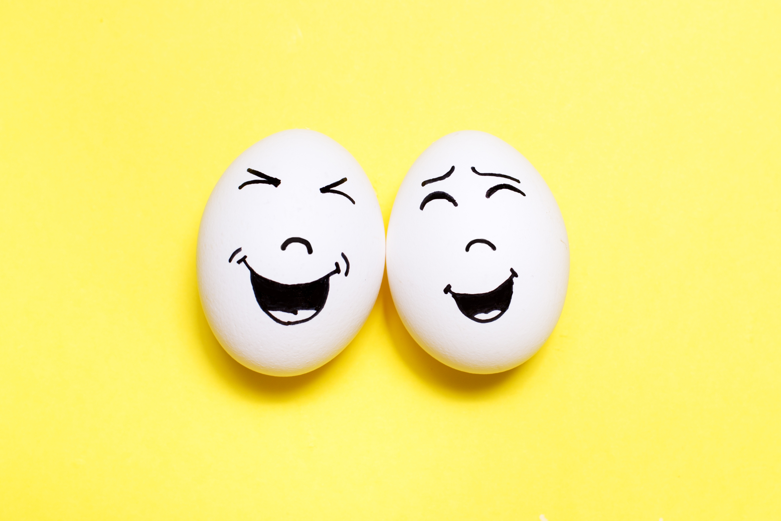two eggs with faces drawn on them