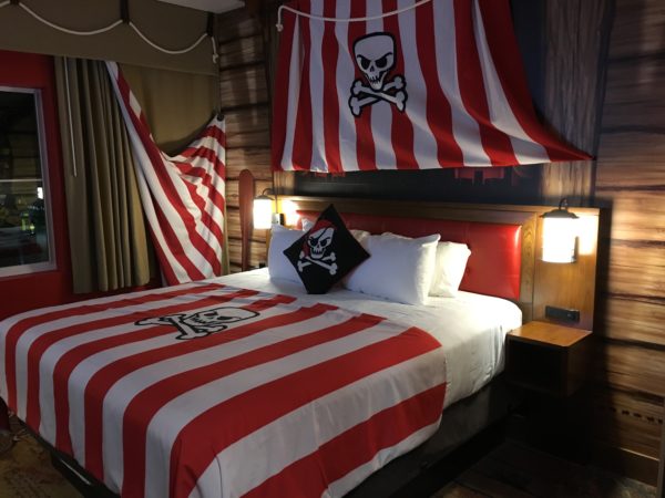 a bed with a pirate flag over it