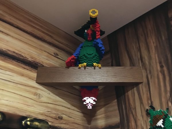 a bird made of legos on a shelf