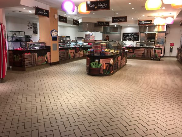 a food court with a counter and shelves
