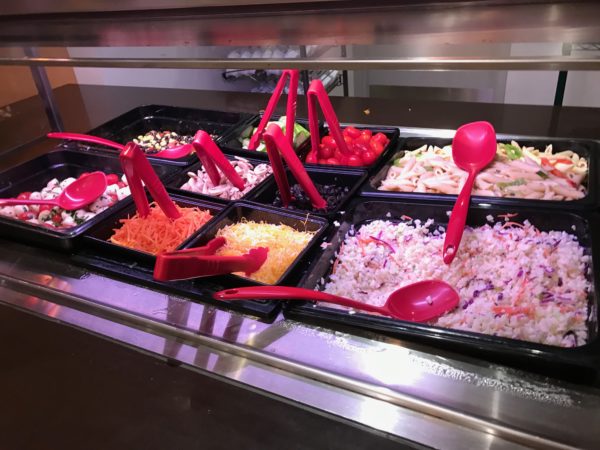 a trays of food with spoons
