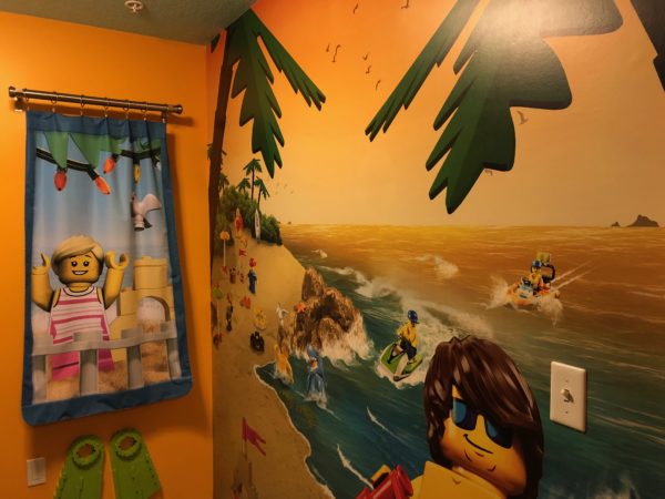 a bathroom with a towel and a wall mural