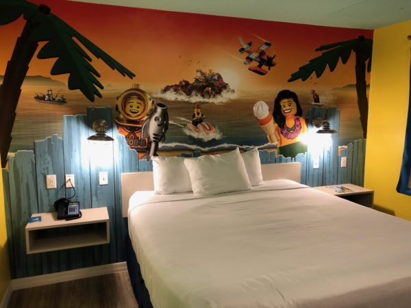 a bed with a wall mural