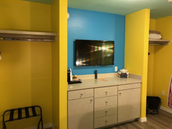 a room with yellow walls and a tv