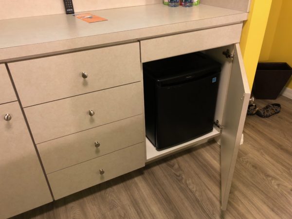 a small refrigerator under a desk