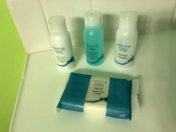 a group of small bottles of shampoo and a pack of soap