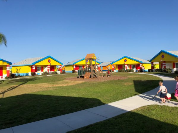 a playground in a row of colorful houses