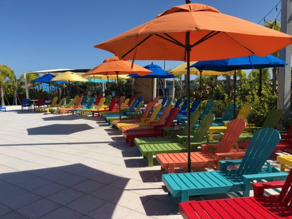 a group of colorful chairs and umbrellas