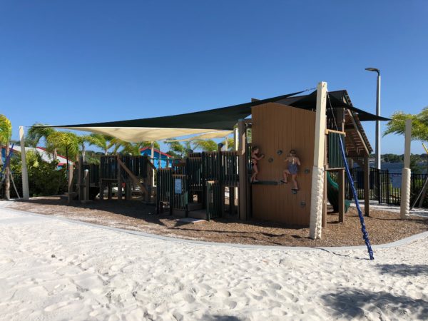 a playground with a shade on the side