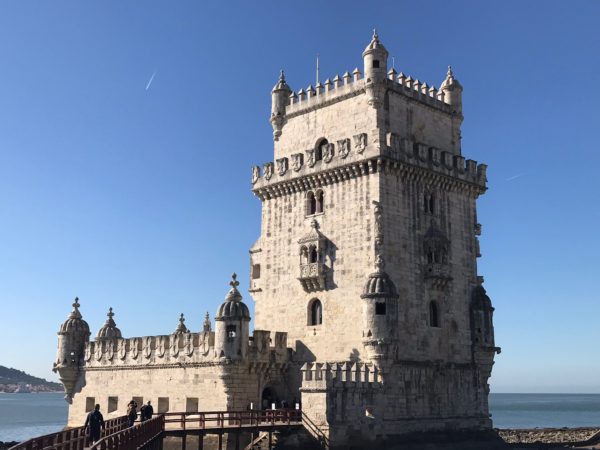 a castle with people walking on Belém Tower
