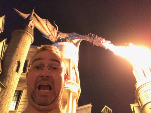 a man taking a selfie with a dragon