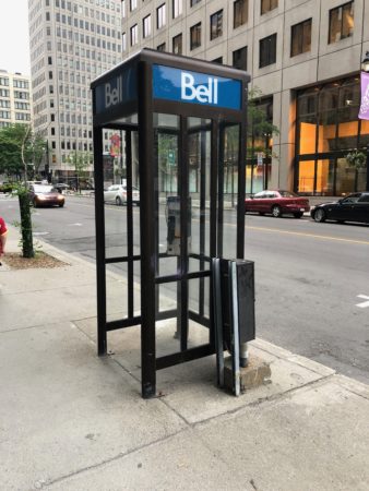 a phone booth on the sidewalk