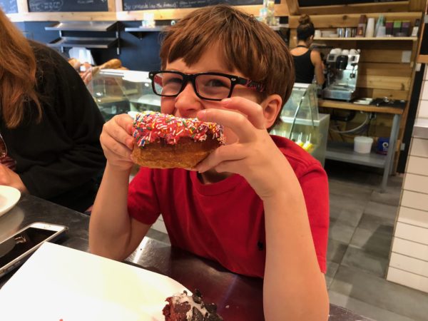 a boy eating a donut