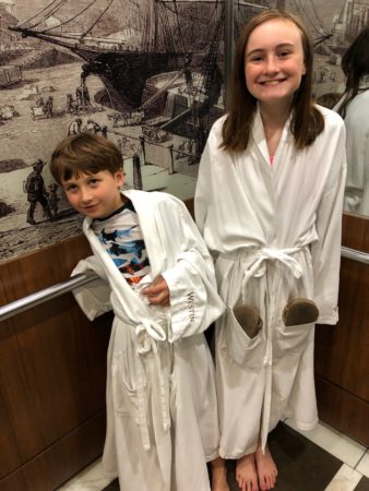a boy and girl wearing white robes