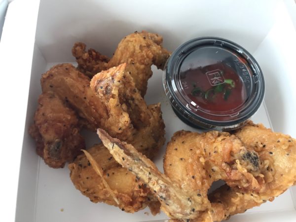 a box of fried chicken wings and sauce