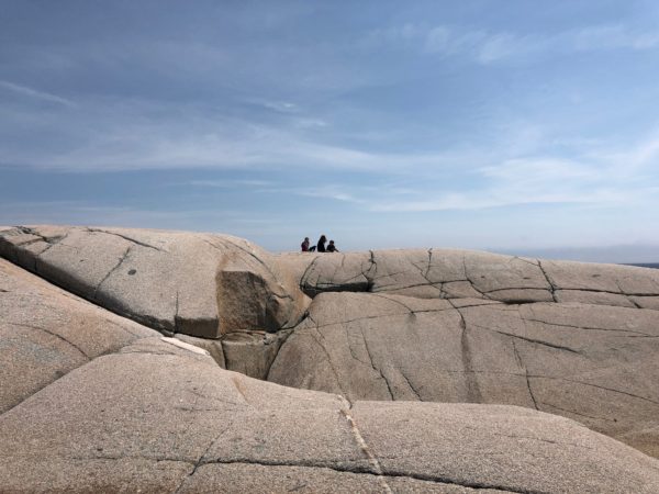 people sitting on a rock