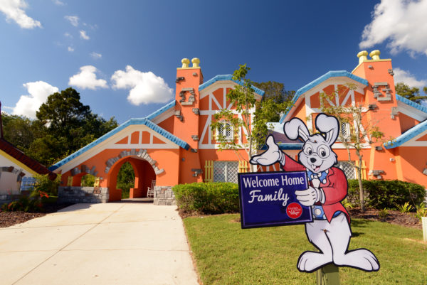 a house with a cartoon rabbit and a sign