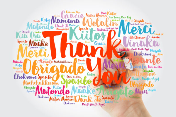 a hand writing a thank you message