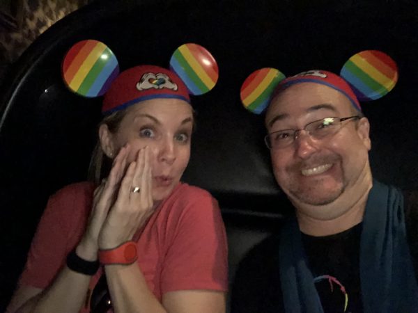 a man and woman wearing mouse ears