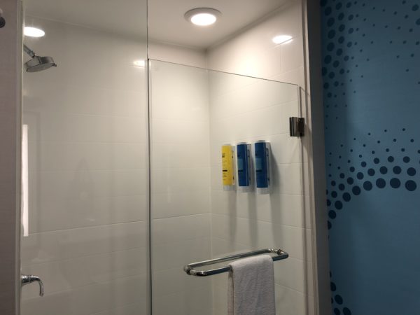 a shower with a towel on a bar
