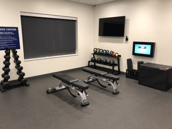 a room with weights and a tv