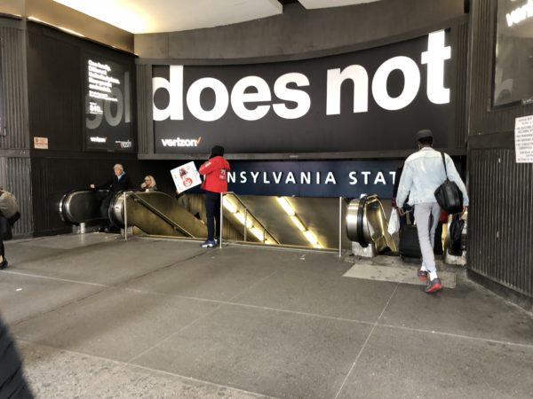 people standing in front of a sign