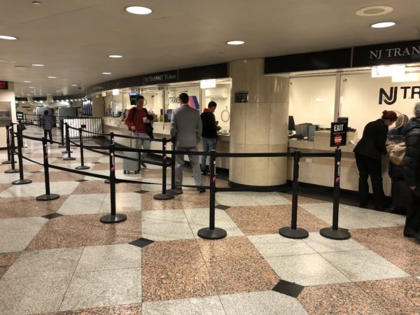 people standing in a line at a check-in counter
