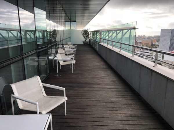 a deck with chairs and a railing