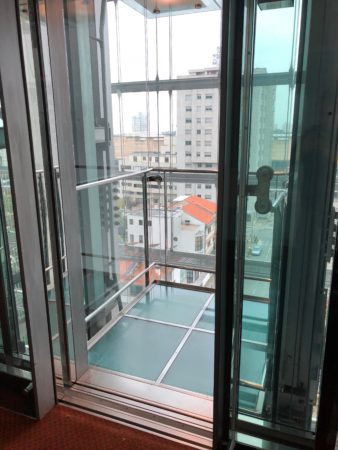 a glass elevator with a glass door