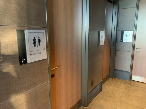 a bathroom doors with signs