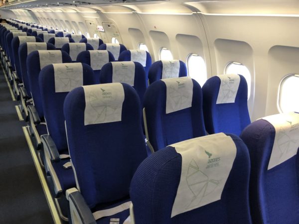 a row of blue seats on an airplane