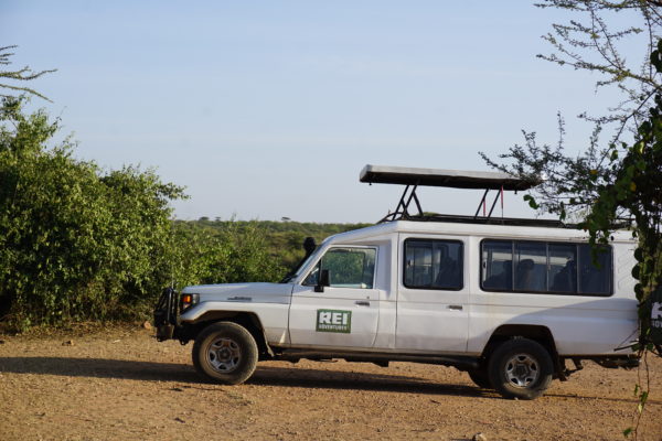 a white vehicle with a roof rack on top