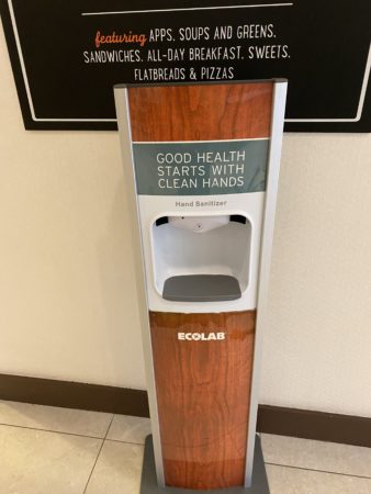 a hand sanitizer dispenser in a room