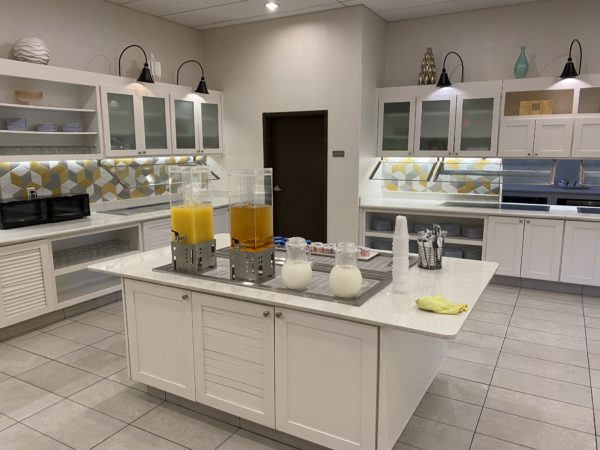 a kitchen with white cabinets and yellow liquid