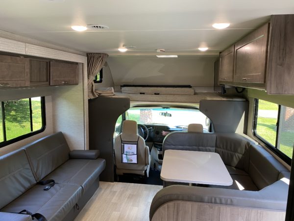 inside a rv with a table and chairs