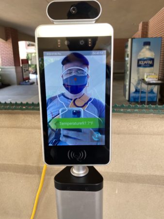 a smart phone with a face mask on