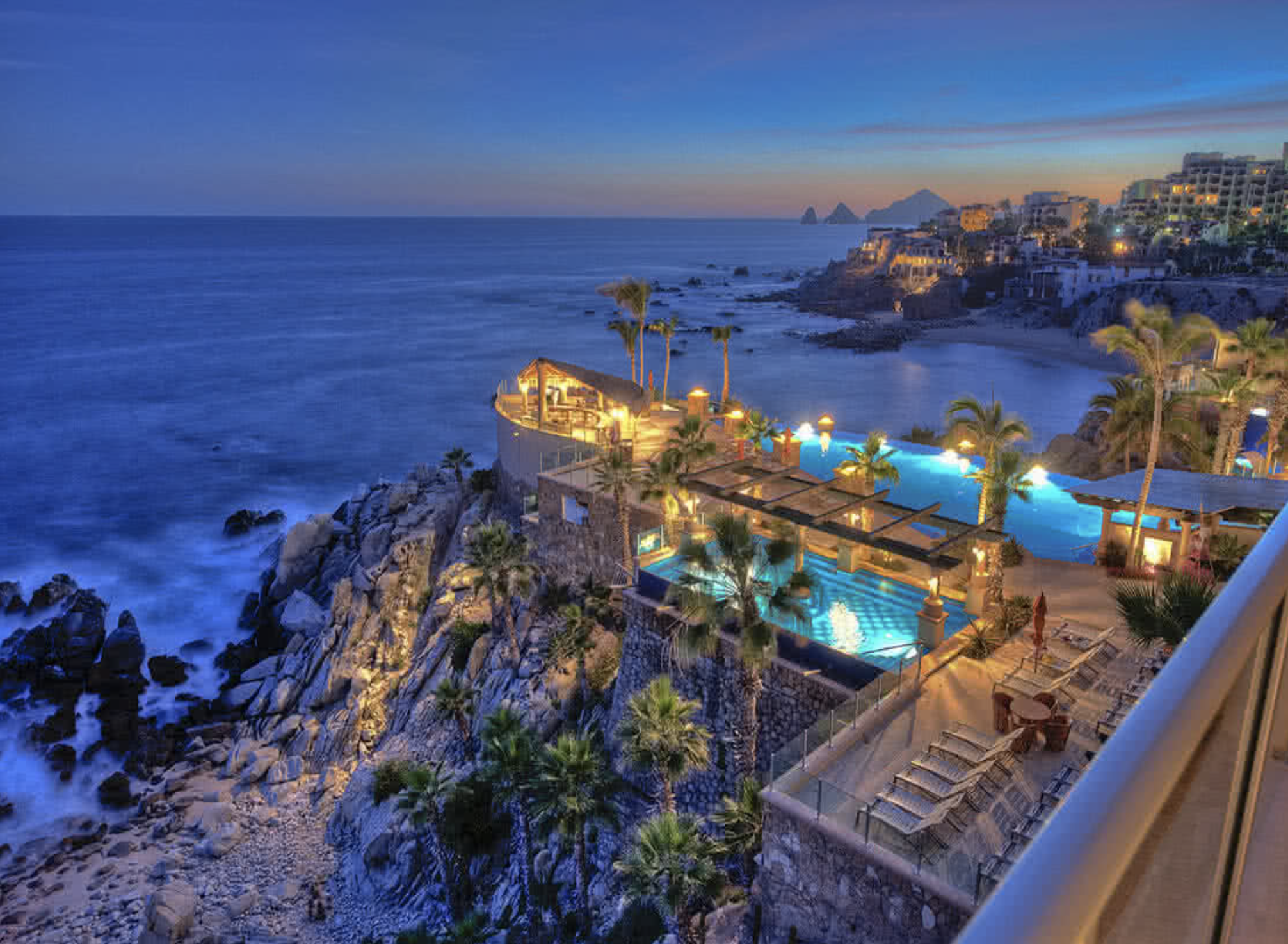 a pool on a cliff overlooking a beach