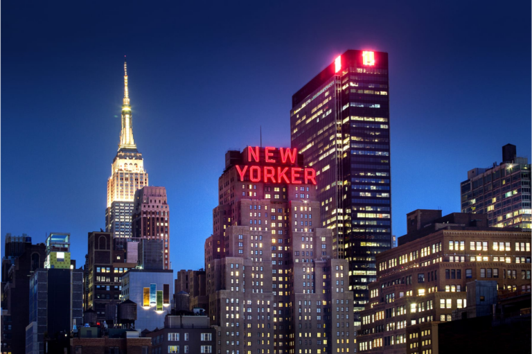 a city skyline with a tall building and a tall spire